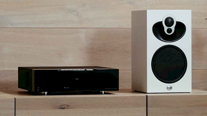 Linn  Majik DSM next to white Linn speaker on wooden shelf