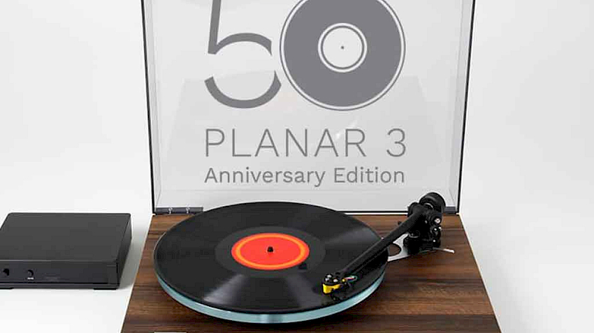 Rega Planar 3 50th anniversary turntable with wood effect on a white background