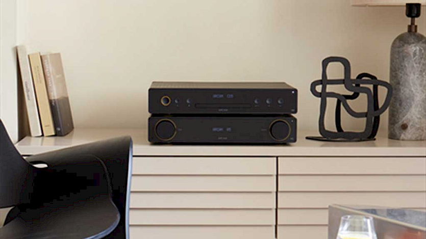 arcam radia a15 and cd5 on sideboard with black wooden chair on the right anf a lamp on the left